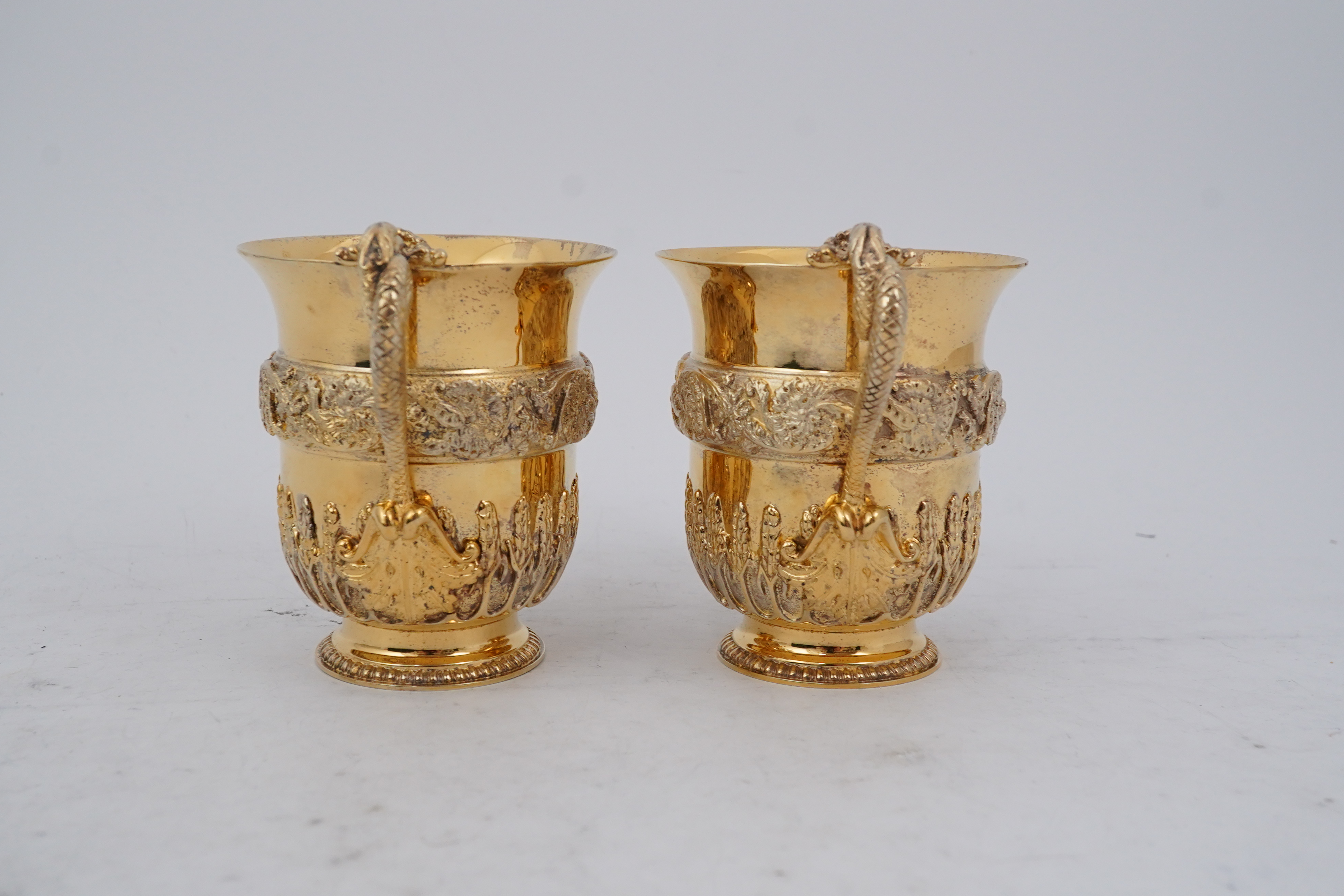 An ornate pair of Elizabeth II silver gilt cups, by Richard O.A. Jarvis